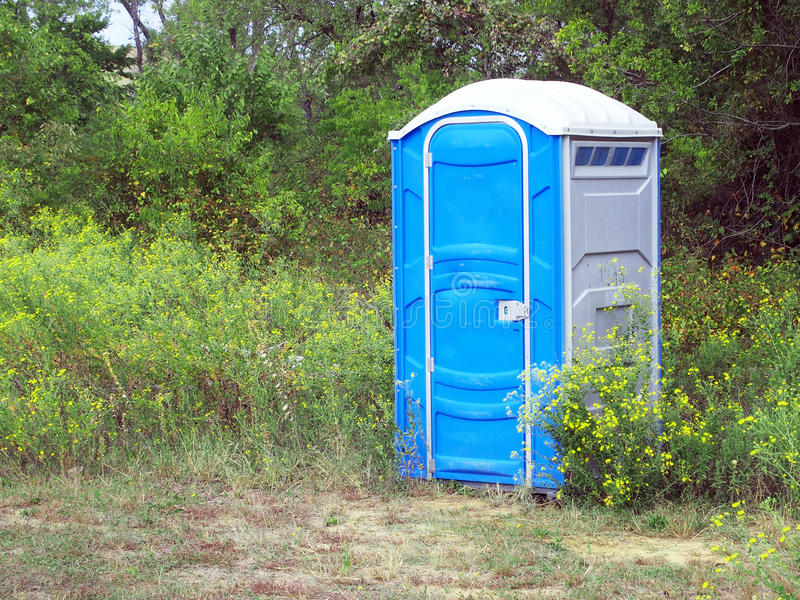 porta-potty-sitting-outdoor-setting-edge-meadow-front-trees-wildlife-area-45068183